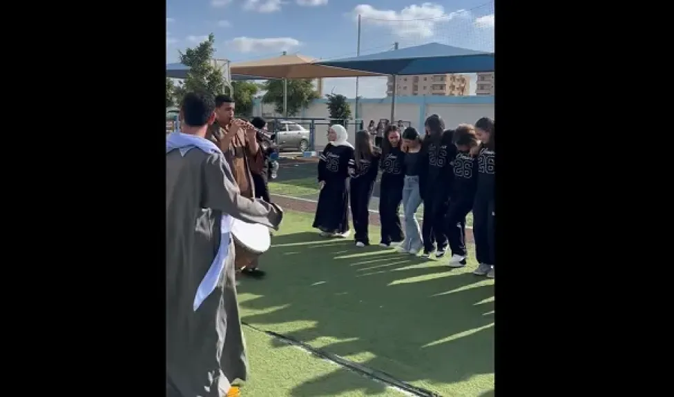 الطلاب يرقصون على المزمار والطبلة
